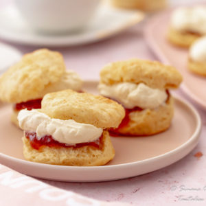 Fluffy perfect buttermilk scones with strawberry jam and whipped cream