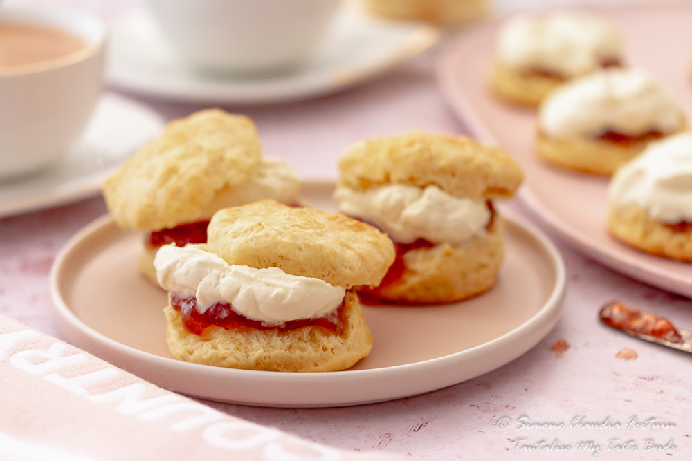 Fluffy perfect buttermilk scones with strawberry jam and whipped cream