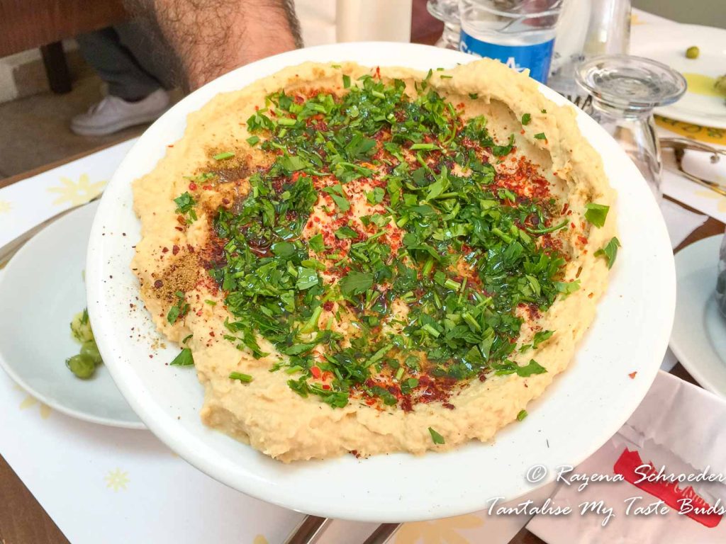 Hummus with fresh herbs and chili pepper