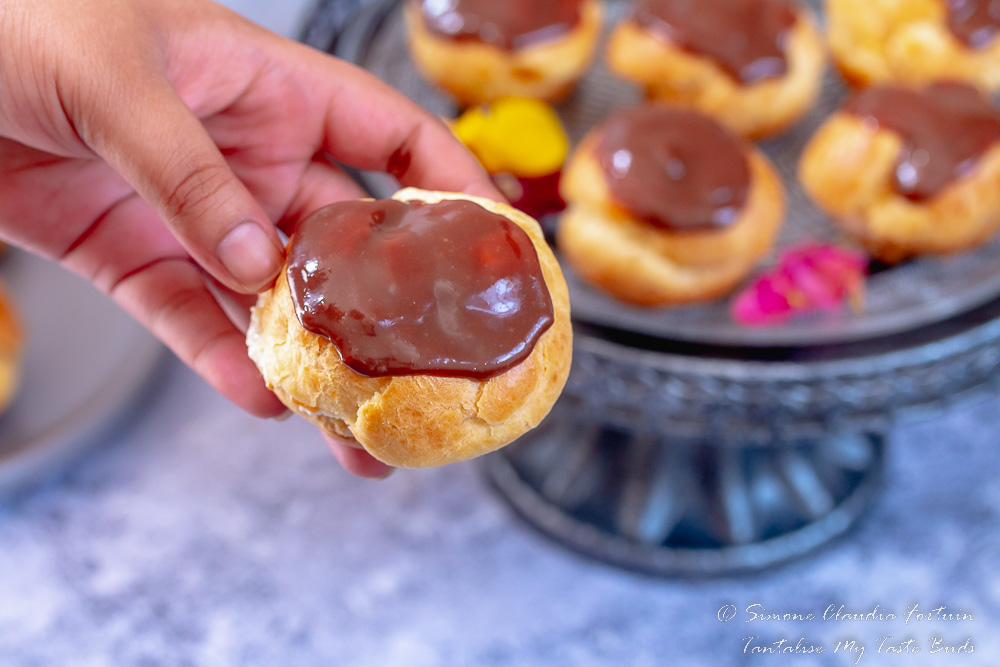 Delicate choux pastry filled with custard and cream and covered in chocolate