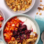 Breakfast mieliepap with granola, blackberry compote and fresh strawberries