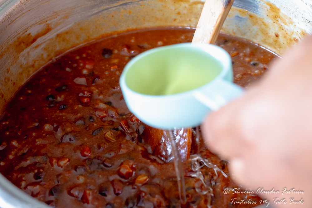 Adding oil to boiled Fruit Cake mixture